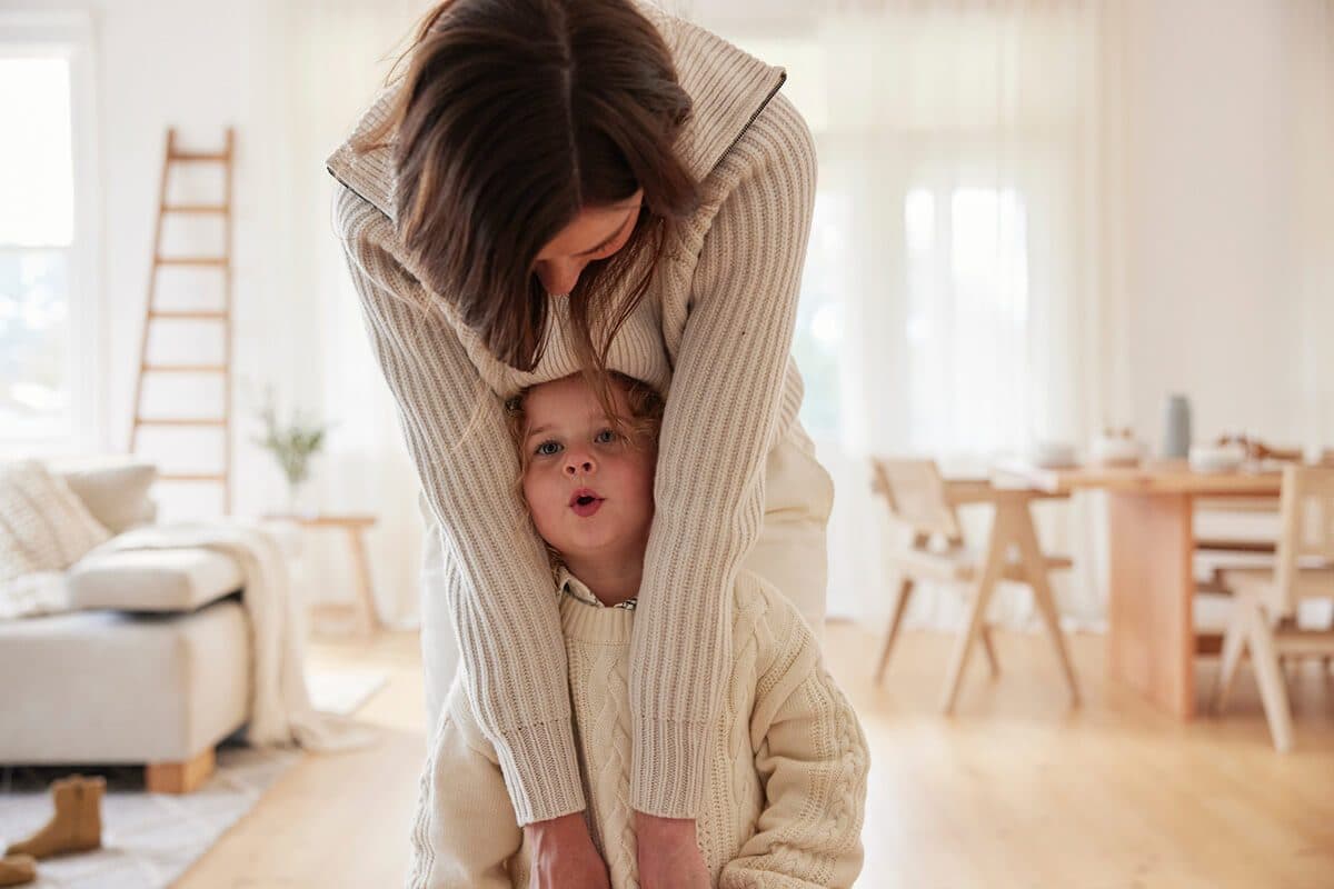 A mother hugging her child at home